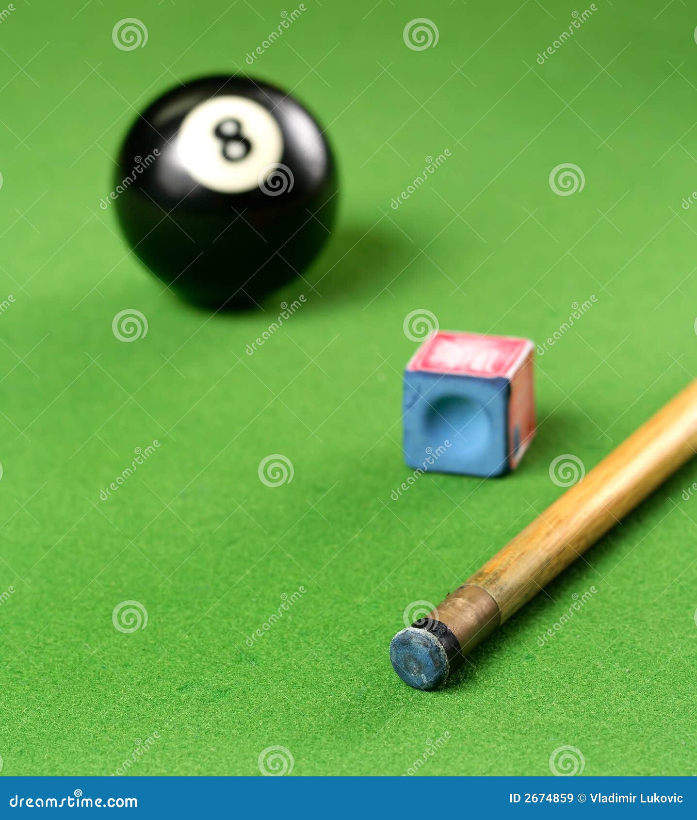 pool cue and 8 ball and chalk