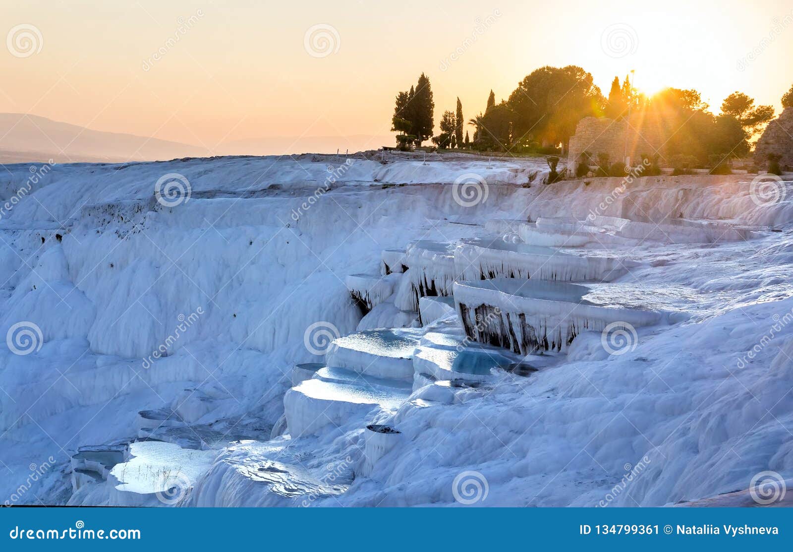 pools of pamukkale in turkey in sunset, contains hot springs and travertines, terraces of carbonate minerals left by water