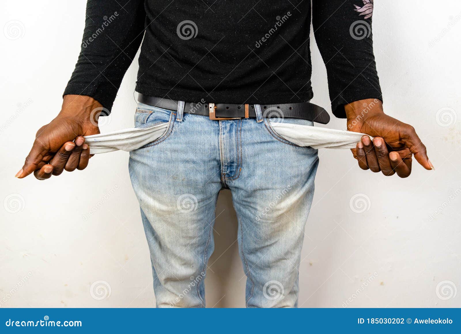 poor african american black man in jeans with empty pocket. for broke concept