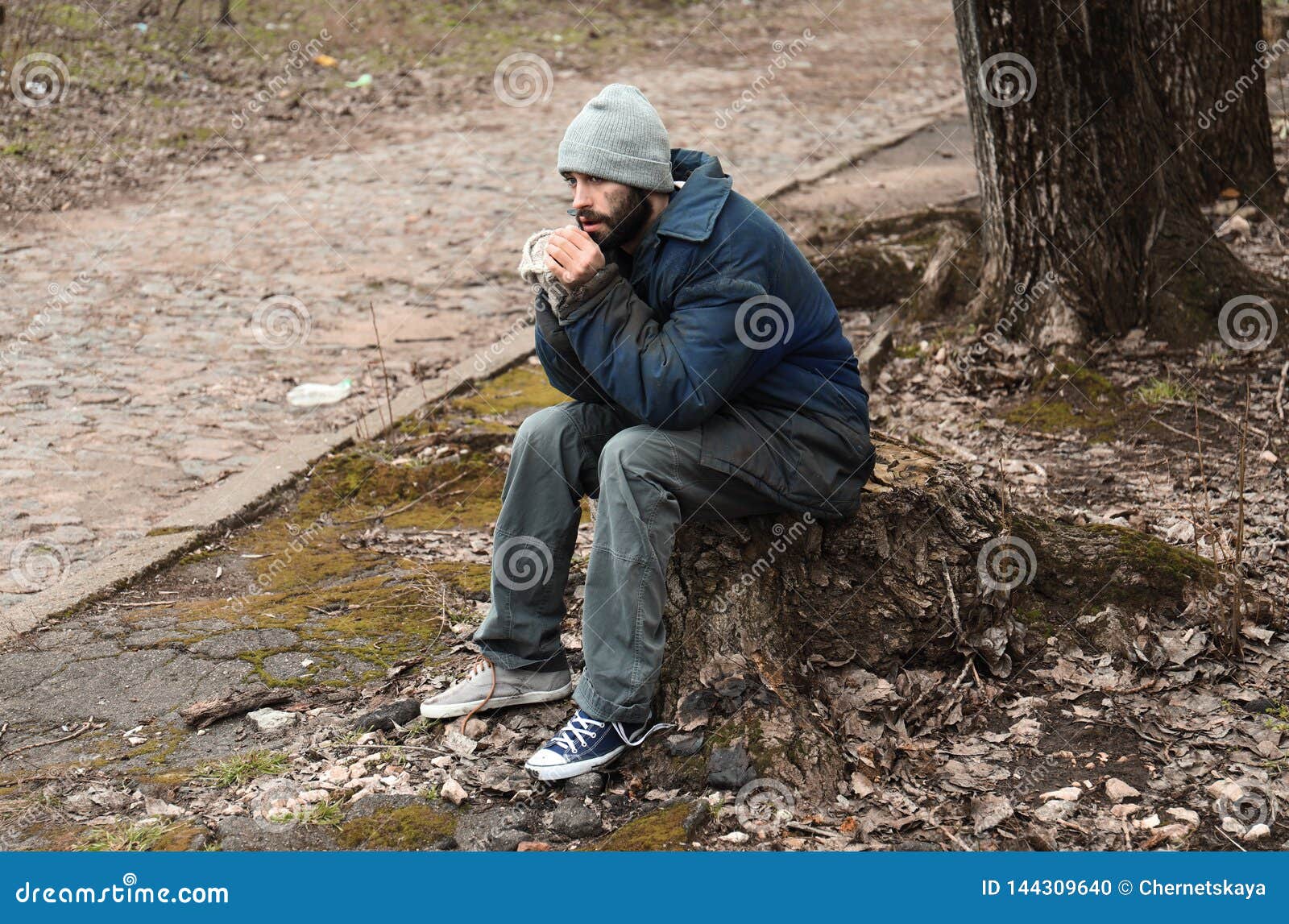 Poor Homeless Man Sitting on Stump Stock Photo - Image of background ...