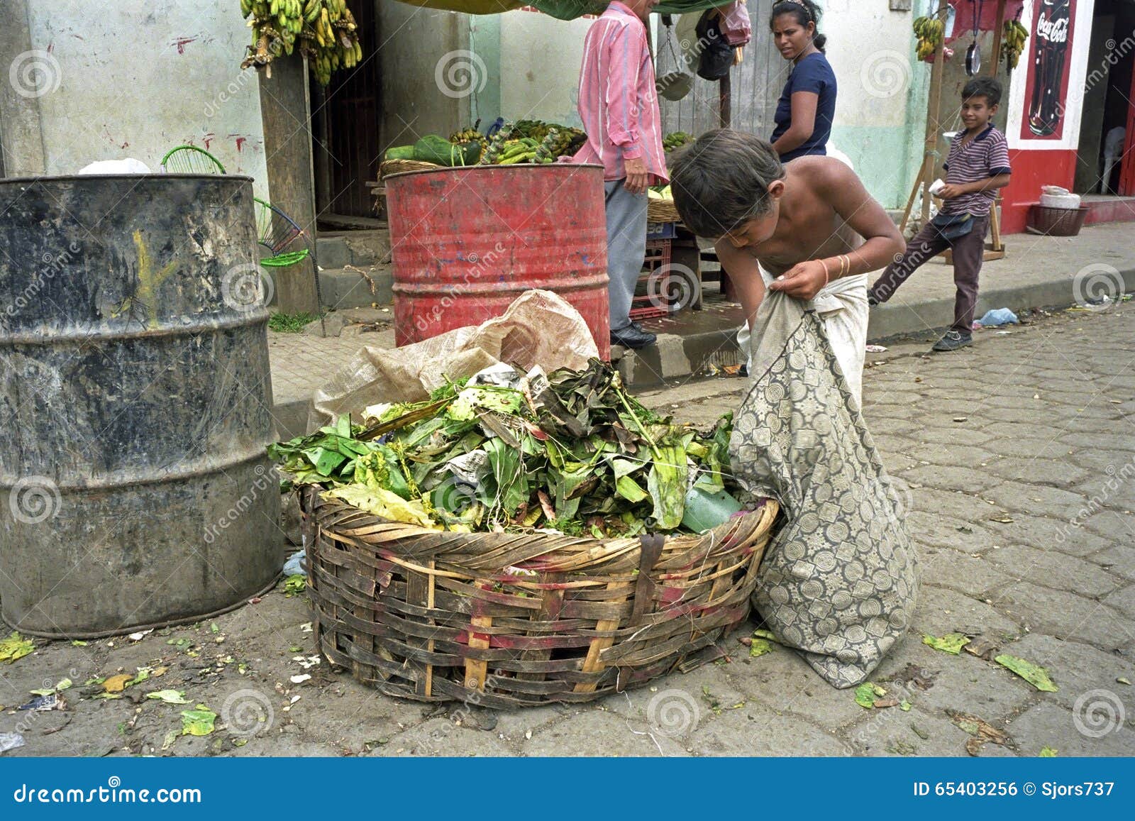 Poor Latino Boy gets food from waste bin, Nicaragua