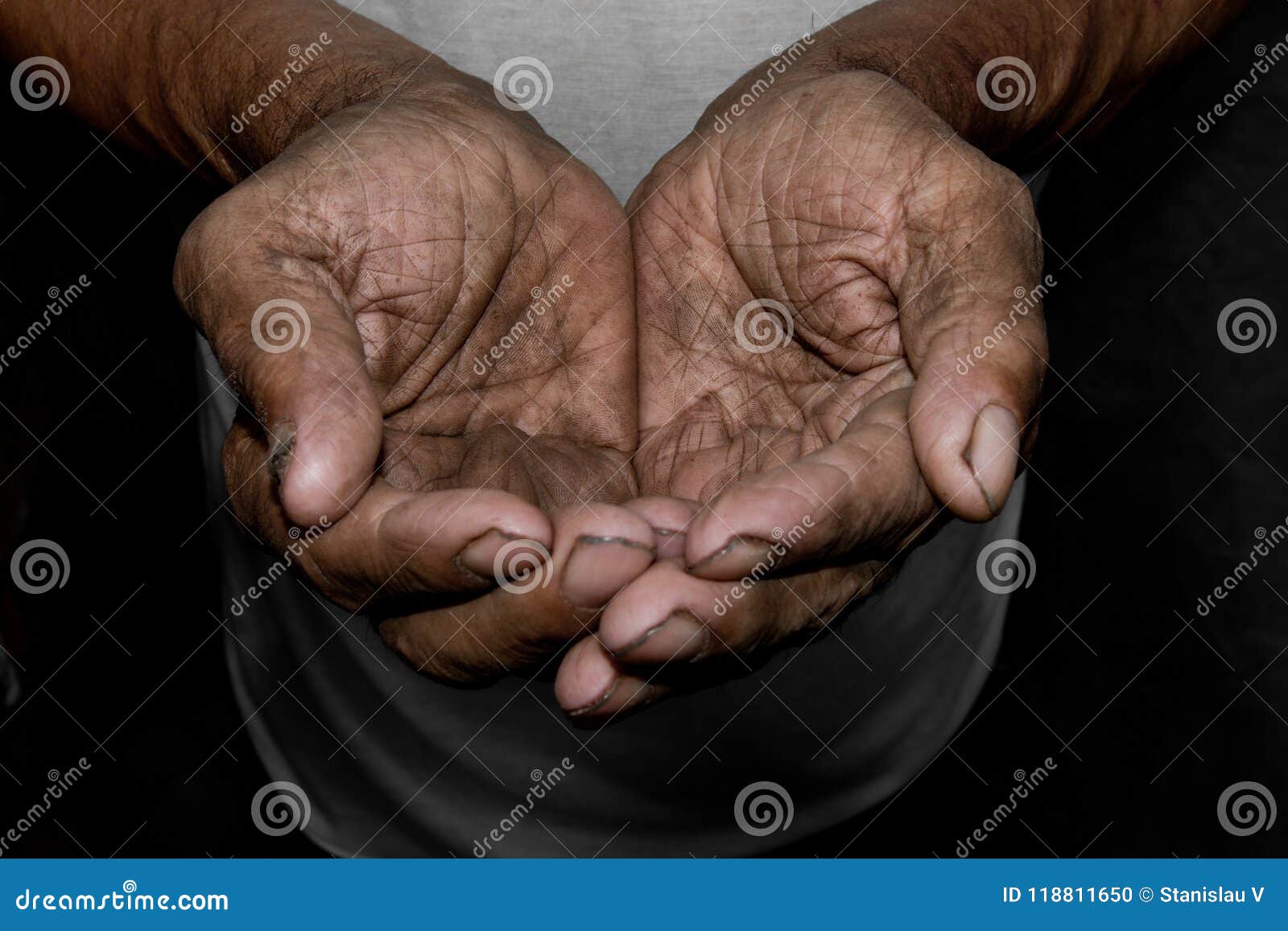 the poor old man`s hands beg you for help. the concept of hunger or poverty. selective focus.