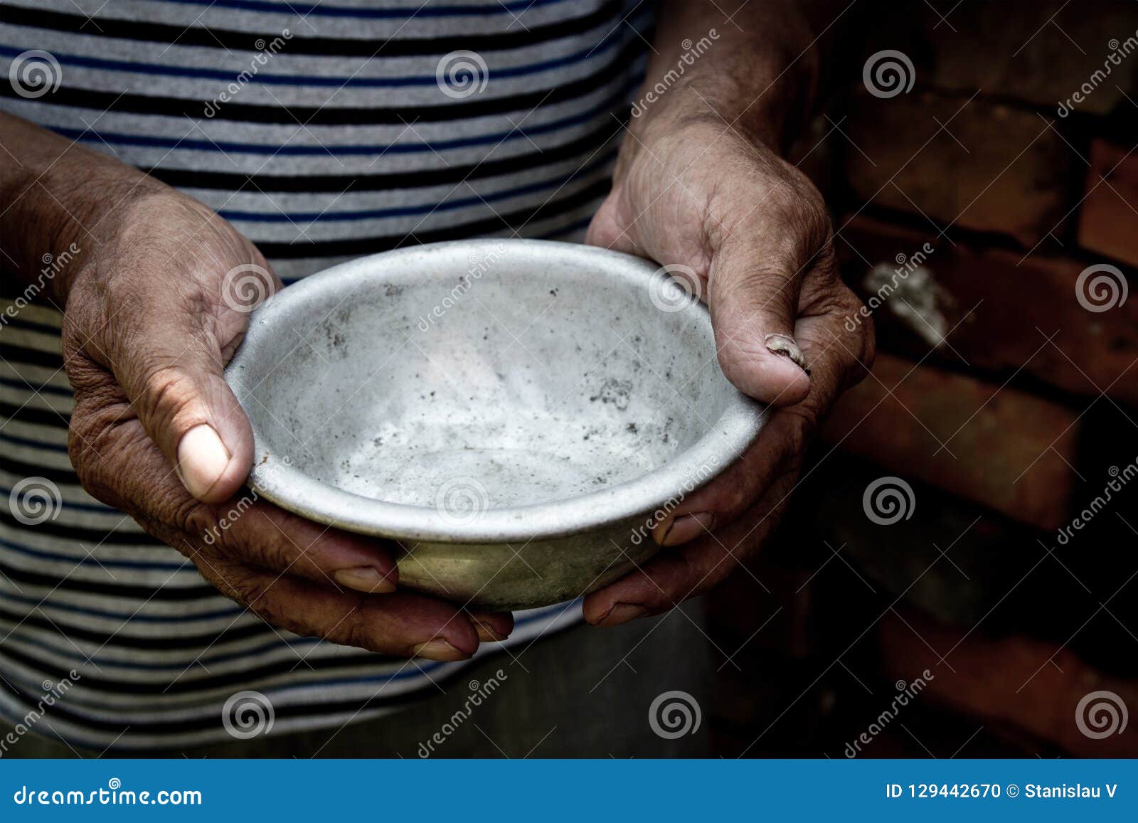 the poor old man`s hands hold an empty bowl. the concept of hunger or poverty. selective focus. poverty in retirement.homeless. al