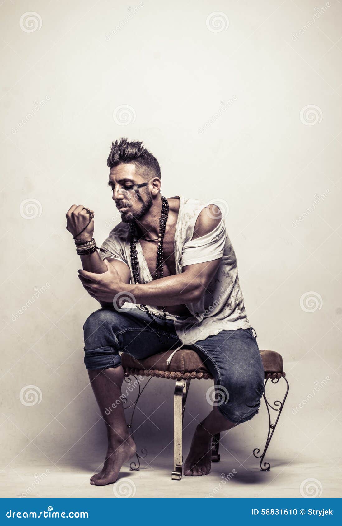 Poor Strong Young Man on a Chair Clenching Fist Stock Photo - Image of ...