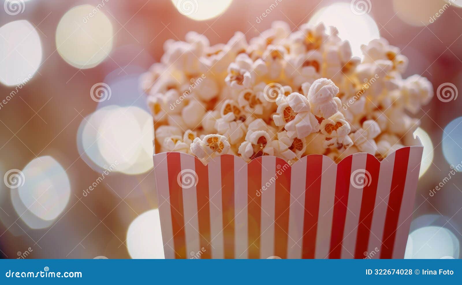 popcorn in a red and white box with a bokeh background.