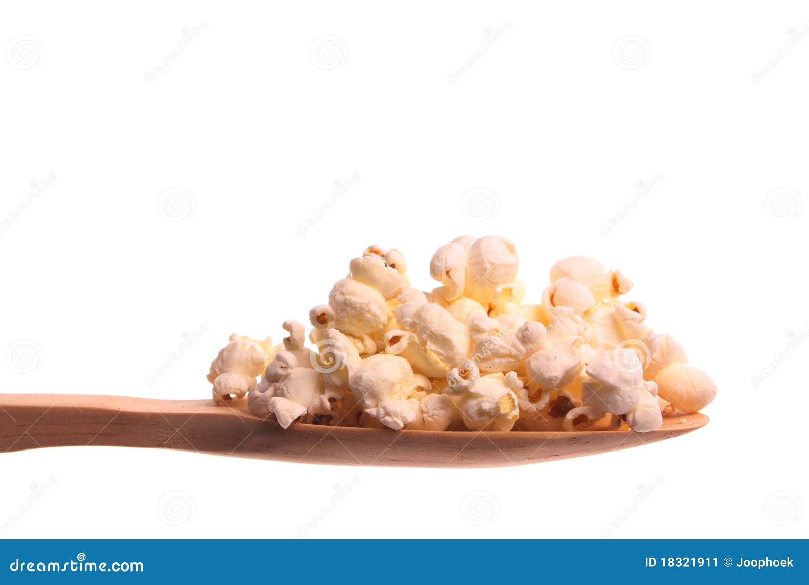 Popcorn on a wooden spoon stock image. Image of offer 18321911