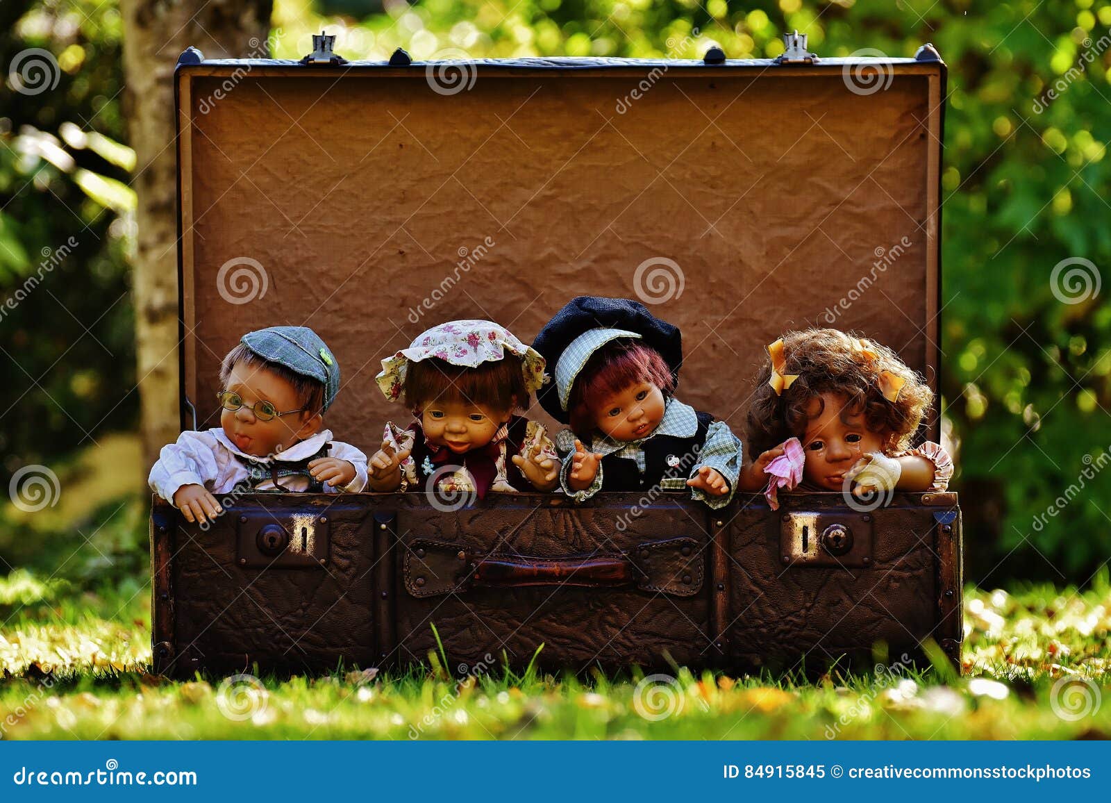4 Porcelain Dolls In Brown Rectangular Box Picture. Image 84915845