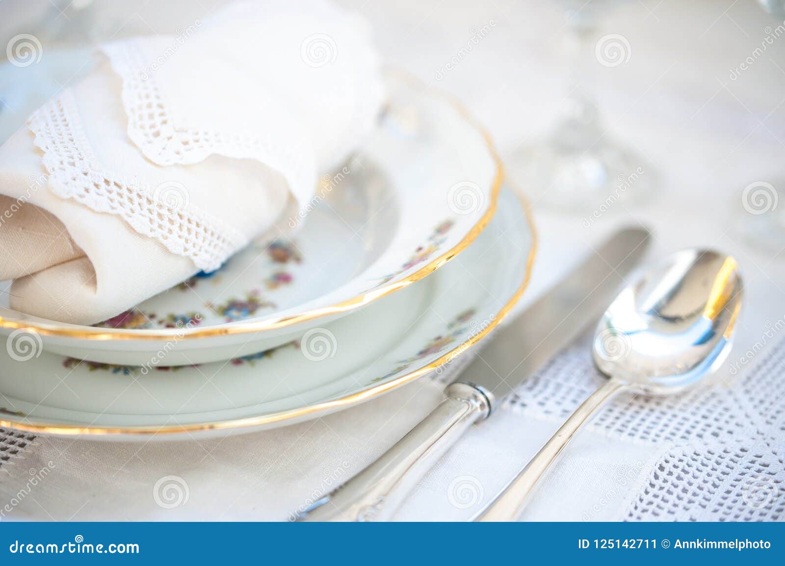 Porcelain Plates, Silver Cutlery and Crystal Glasses on an Antique ...