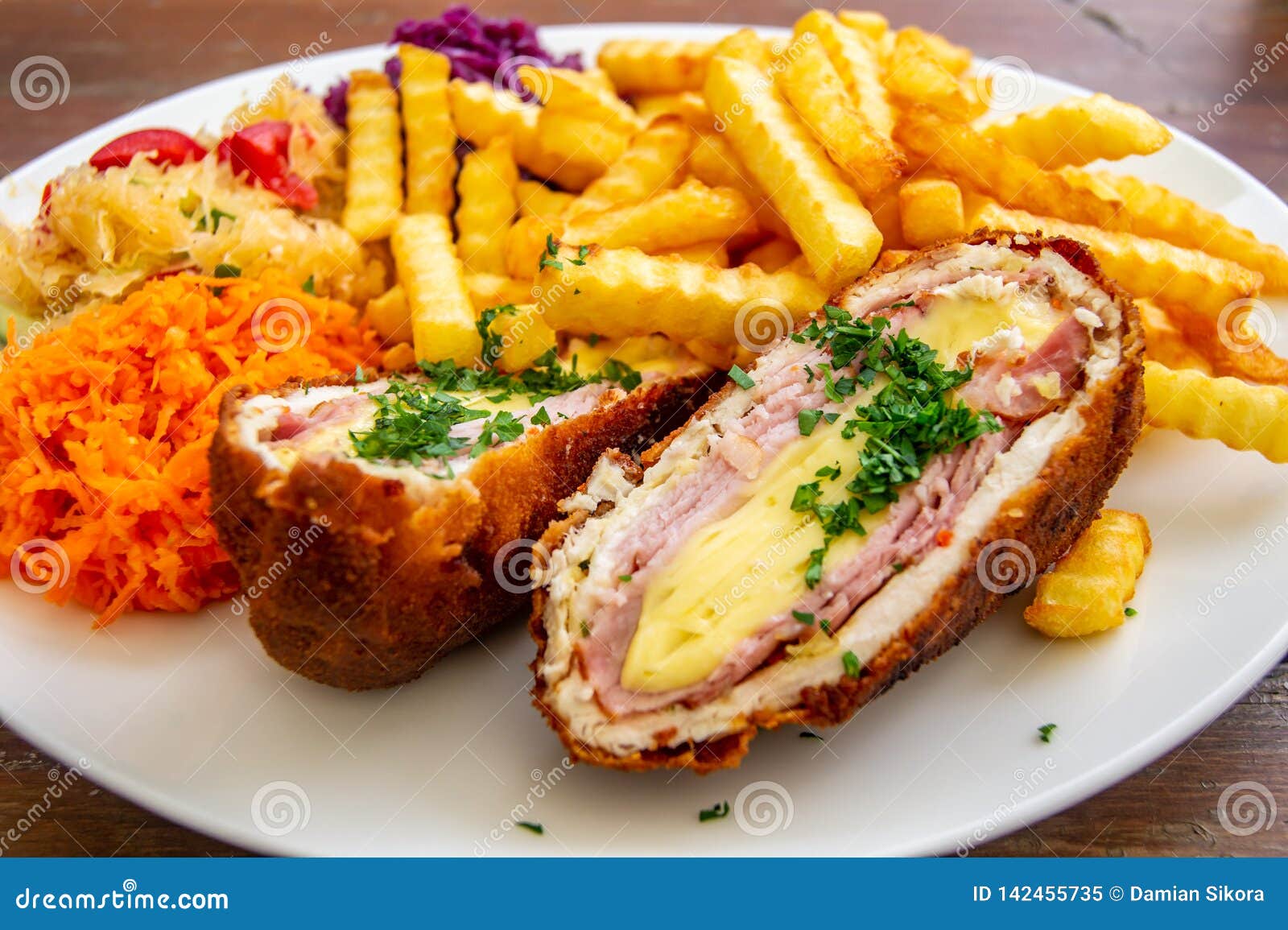 pork devolay. chop de volaille, chicken breast, chicken meat with cheese, french fries, salads