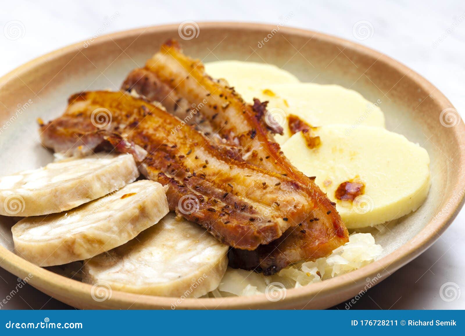 pork meat with two types of dumplings and cabbage