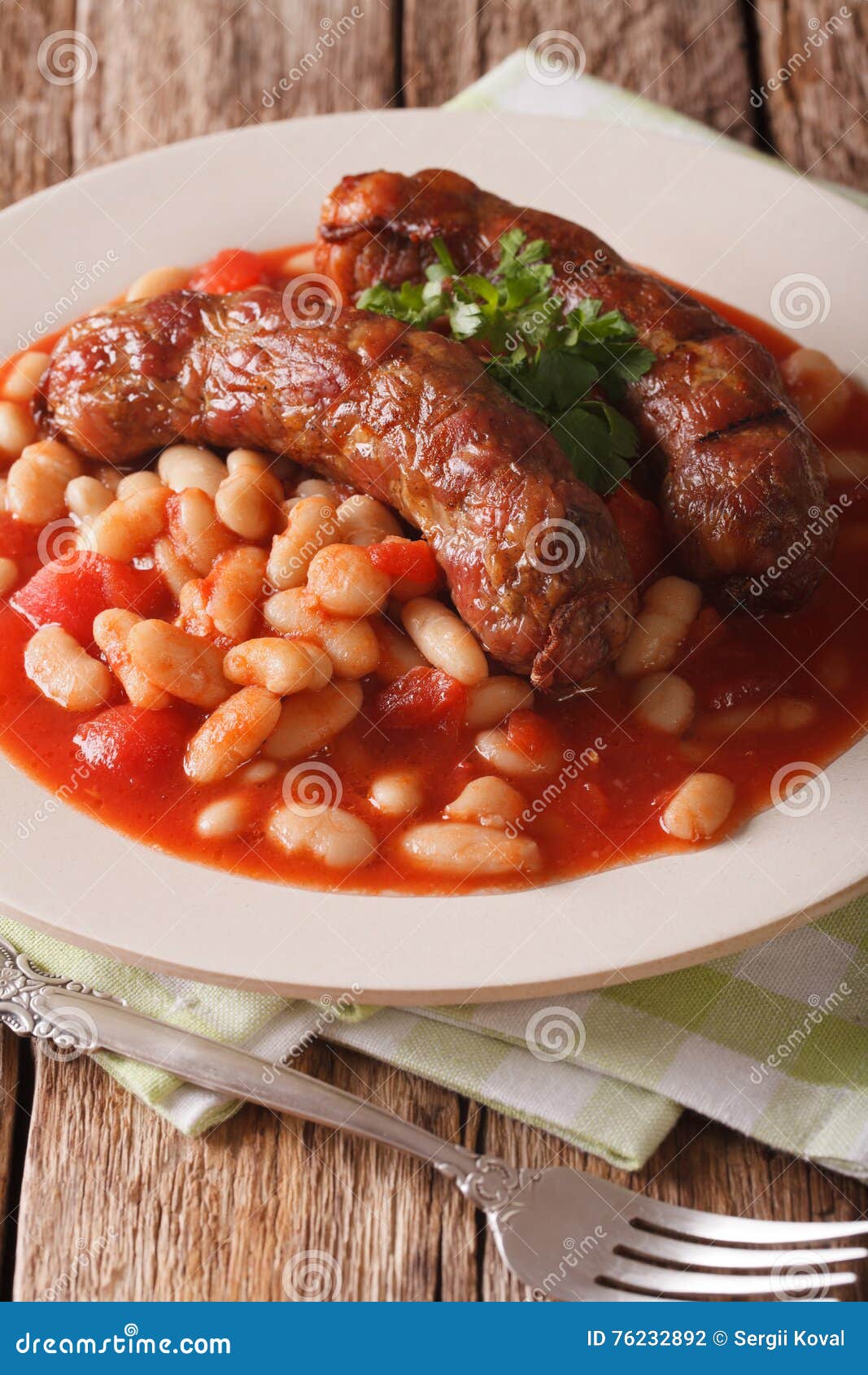 Pork Sausages with Beans and Cooked Tomatoes on a Plate Closeup Stock