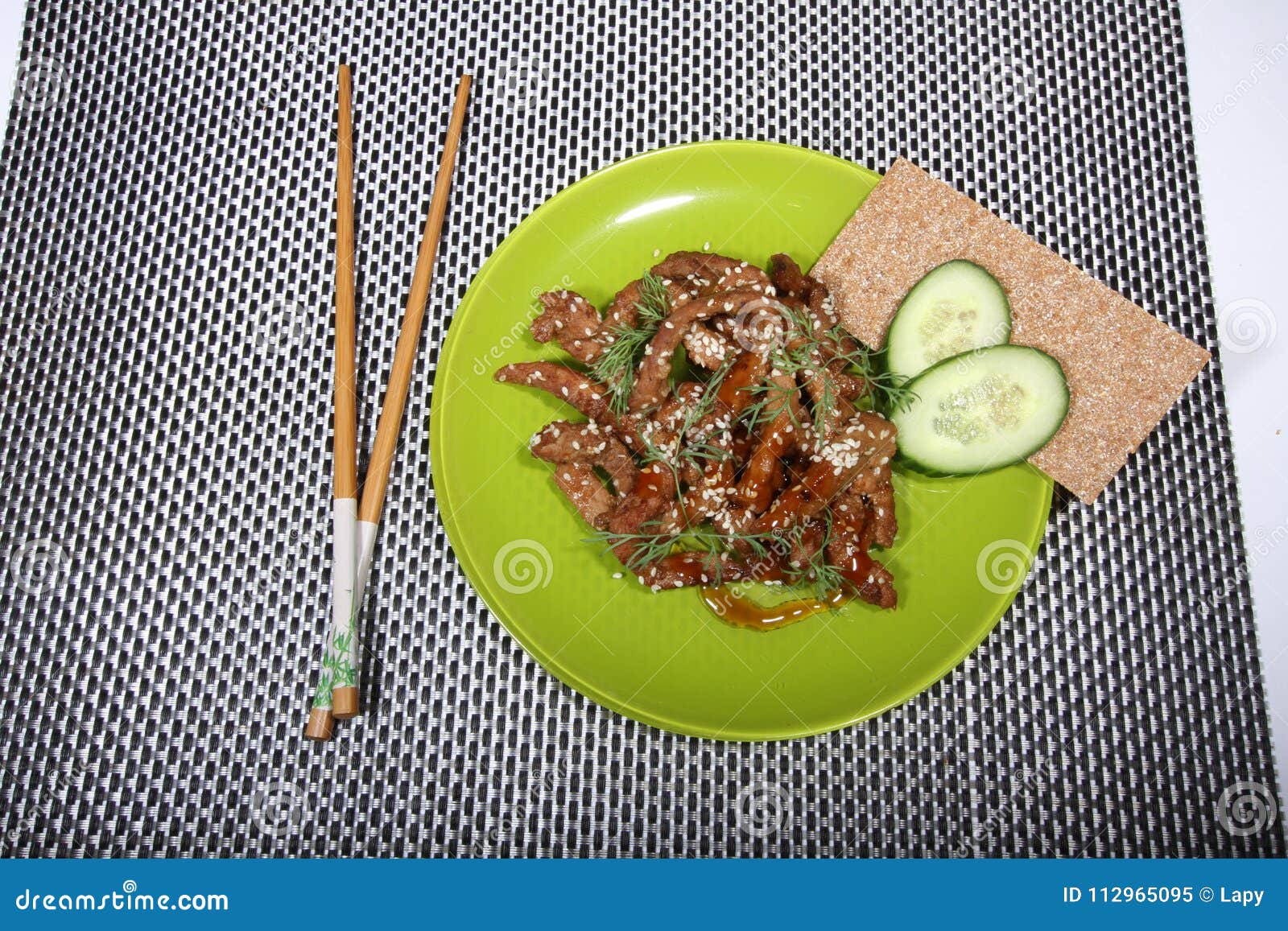 pork in teriyaki sauce with slices of cucumber with cucumber slices and bread