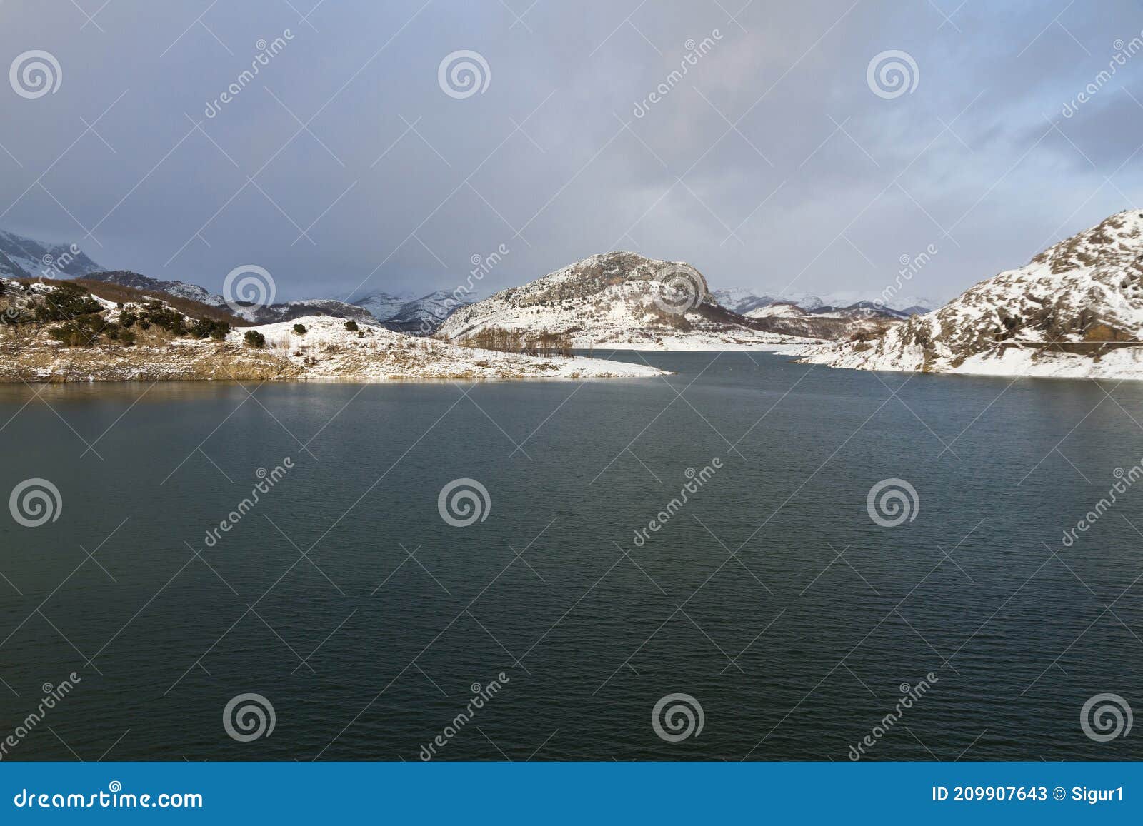 porma reservoir with snow mountains