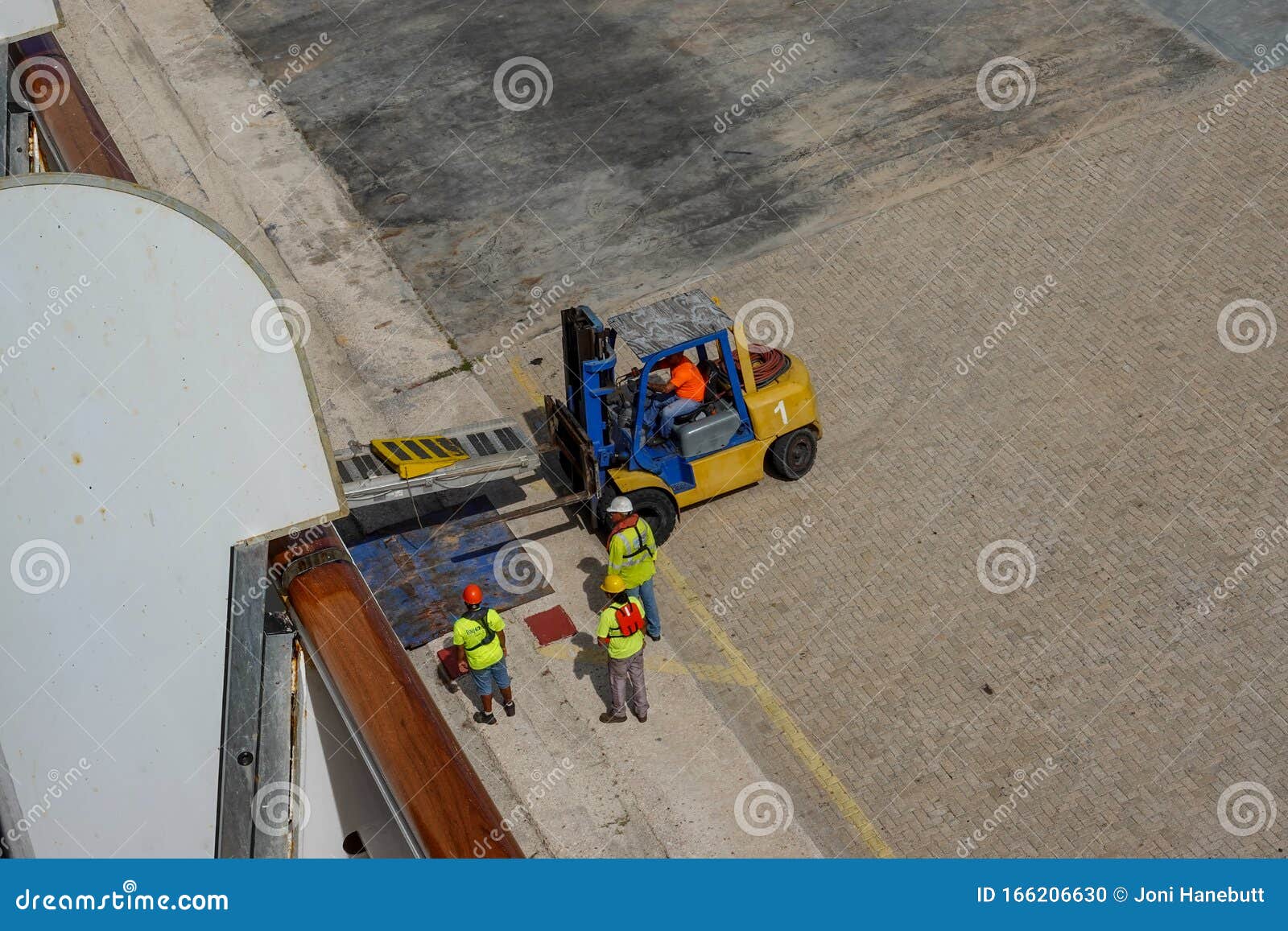 Port Dock Workers Using a Forklift To Setup a Ramp To Transport