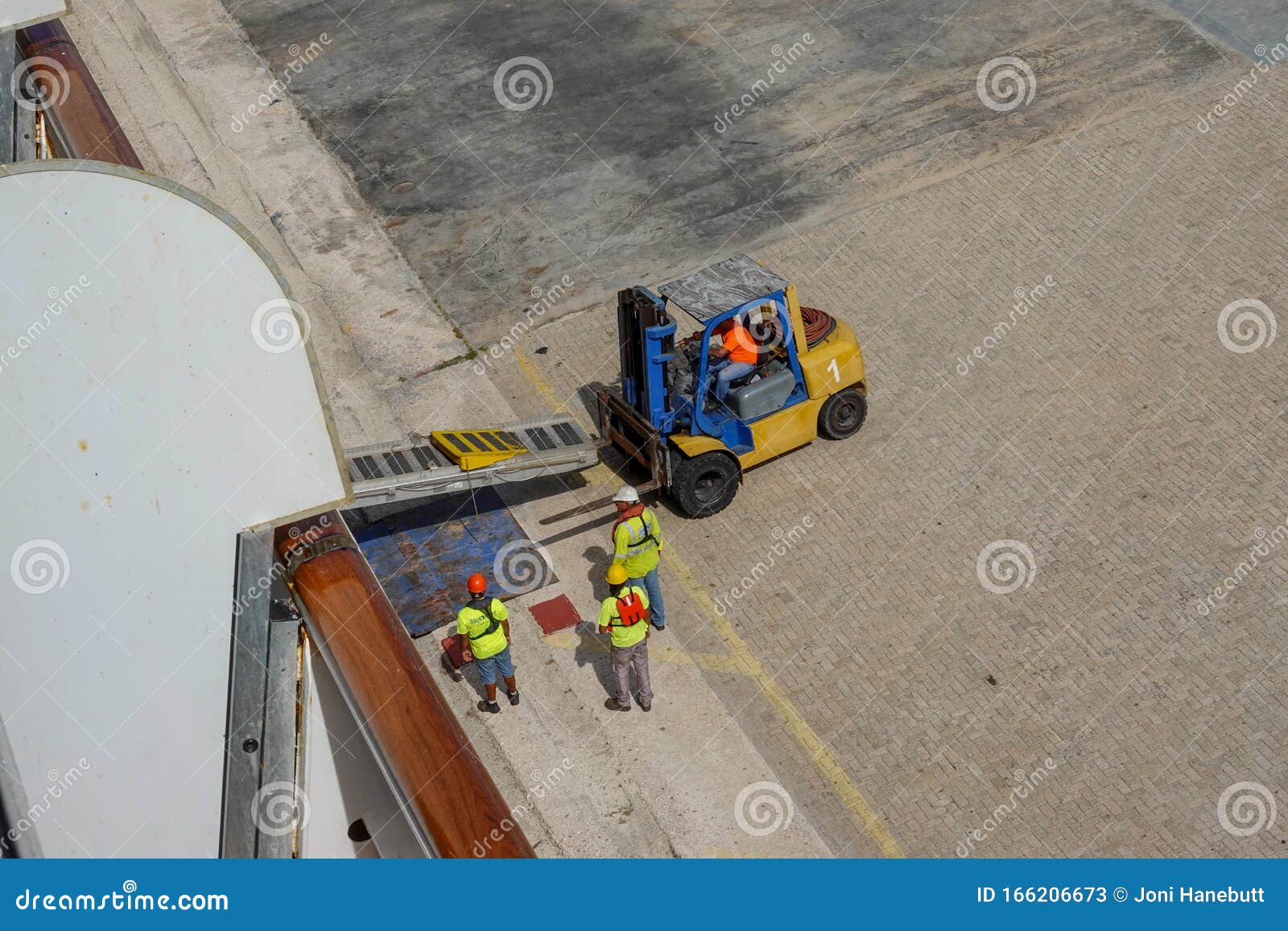 Port Dock Workers Using a Forklift To Setup a Ramp To Transport