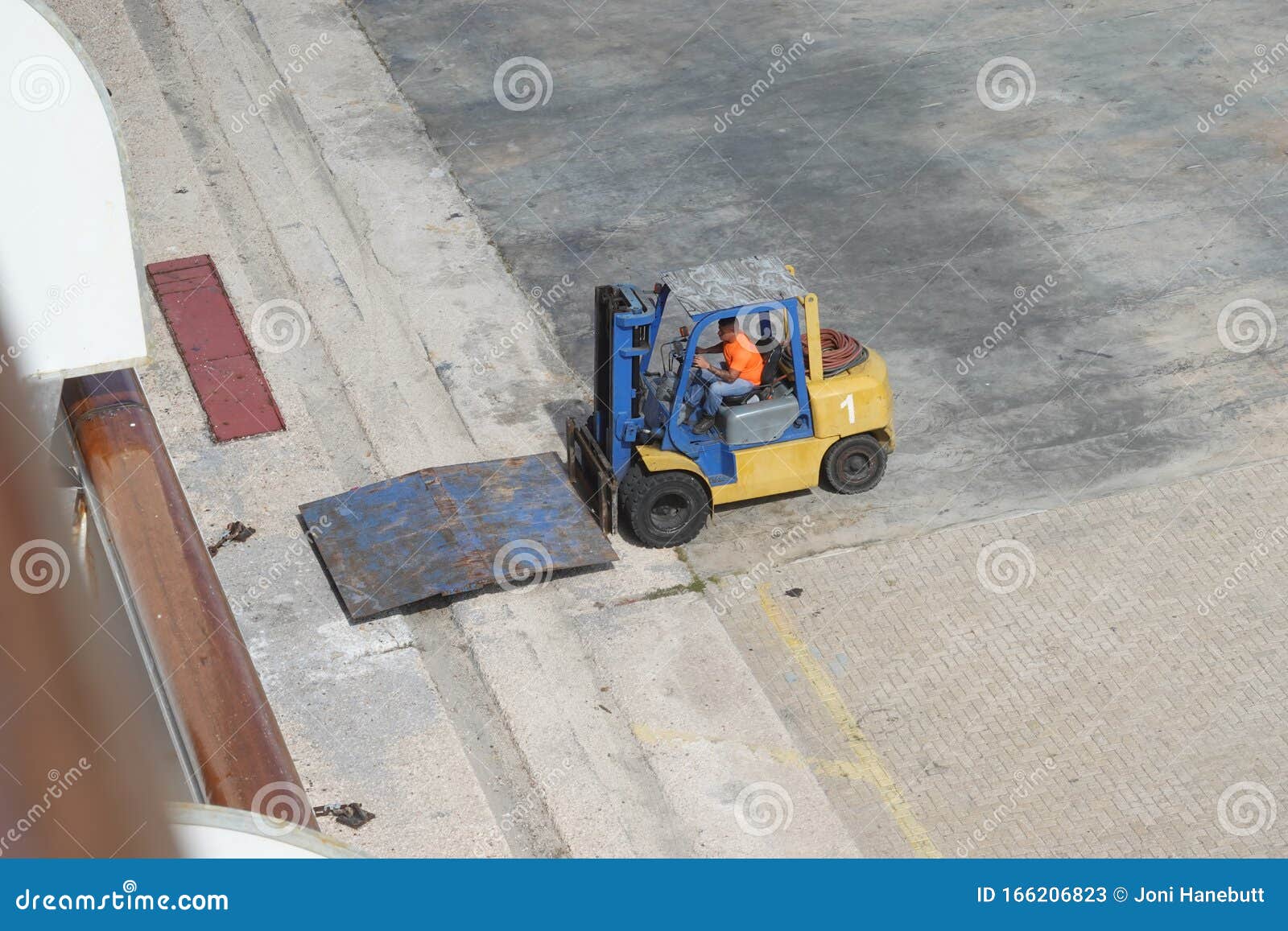 Port Dock Workers Using a Forklift To Setup a Ramp To Transport