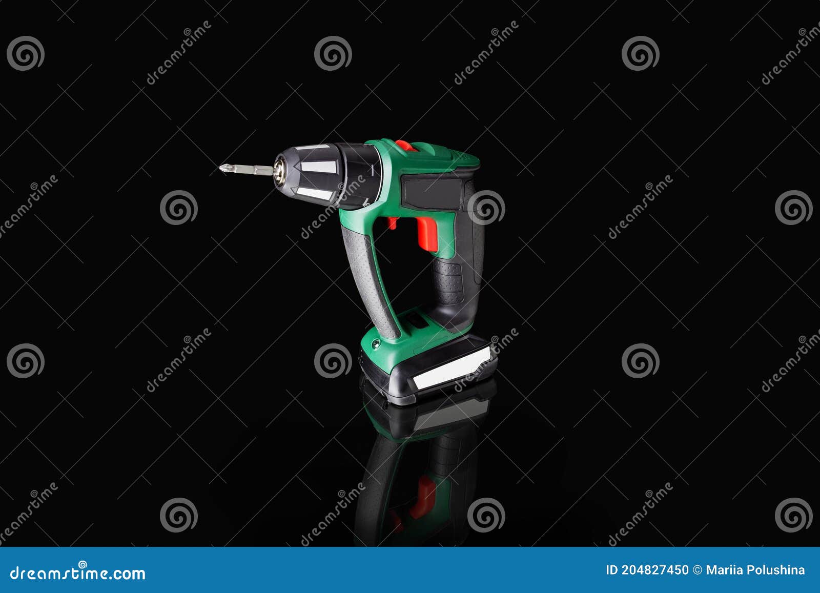 Portable Electric Screwdriver on Black Background on Reflective Surface