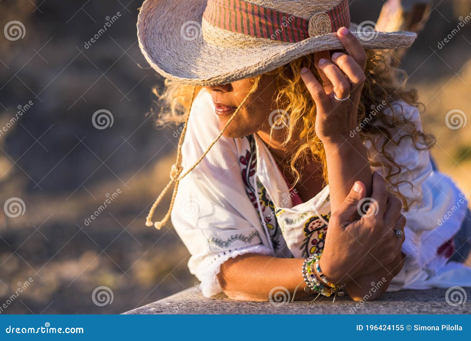 Portait of Beautiful Young Trendy Woman with Cowboy Hat and Accessories  Like Bracelets Lay Down on a Wall Bench Enjoying the Stock Image - Image of  journey, lady: 196424155