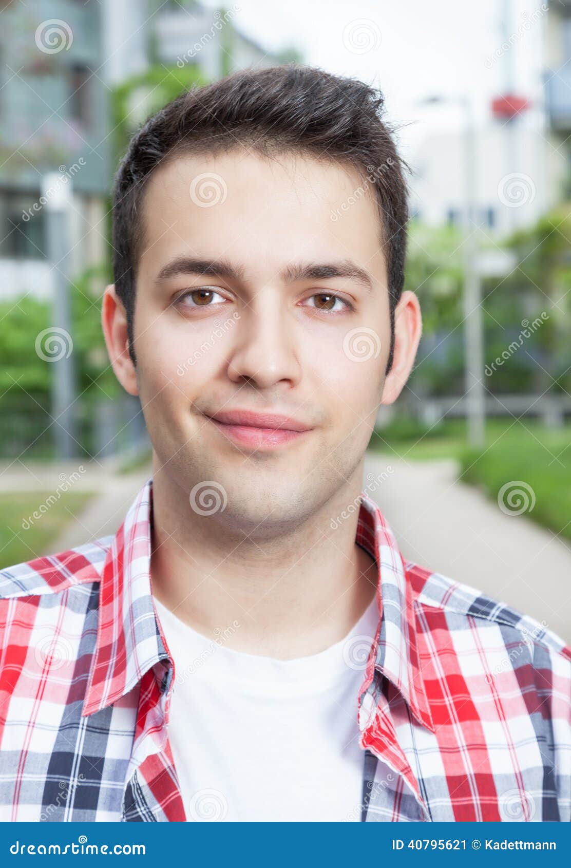portait of a smiling student with checked shirt