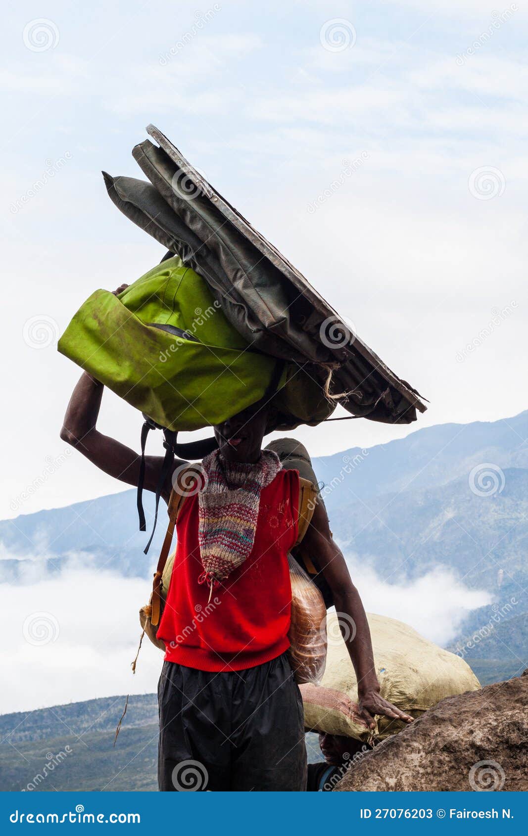 Porter carrying heavy load editorial stock photo. Image of excessive