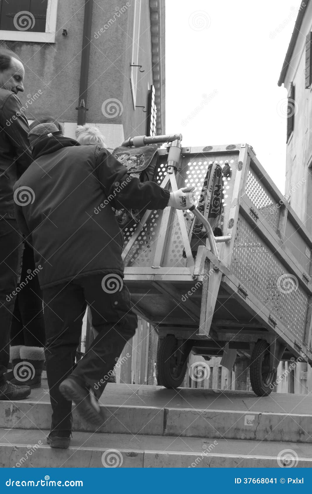 Porter in Venice with Delivery Packages on a Cart Editorial Photo