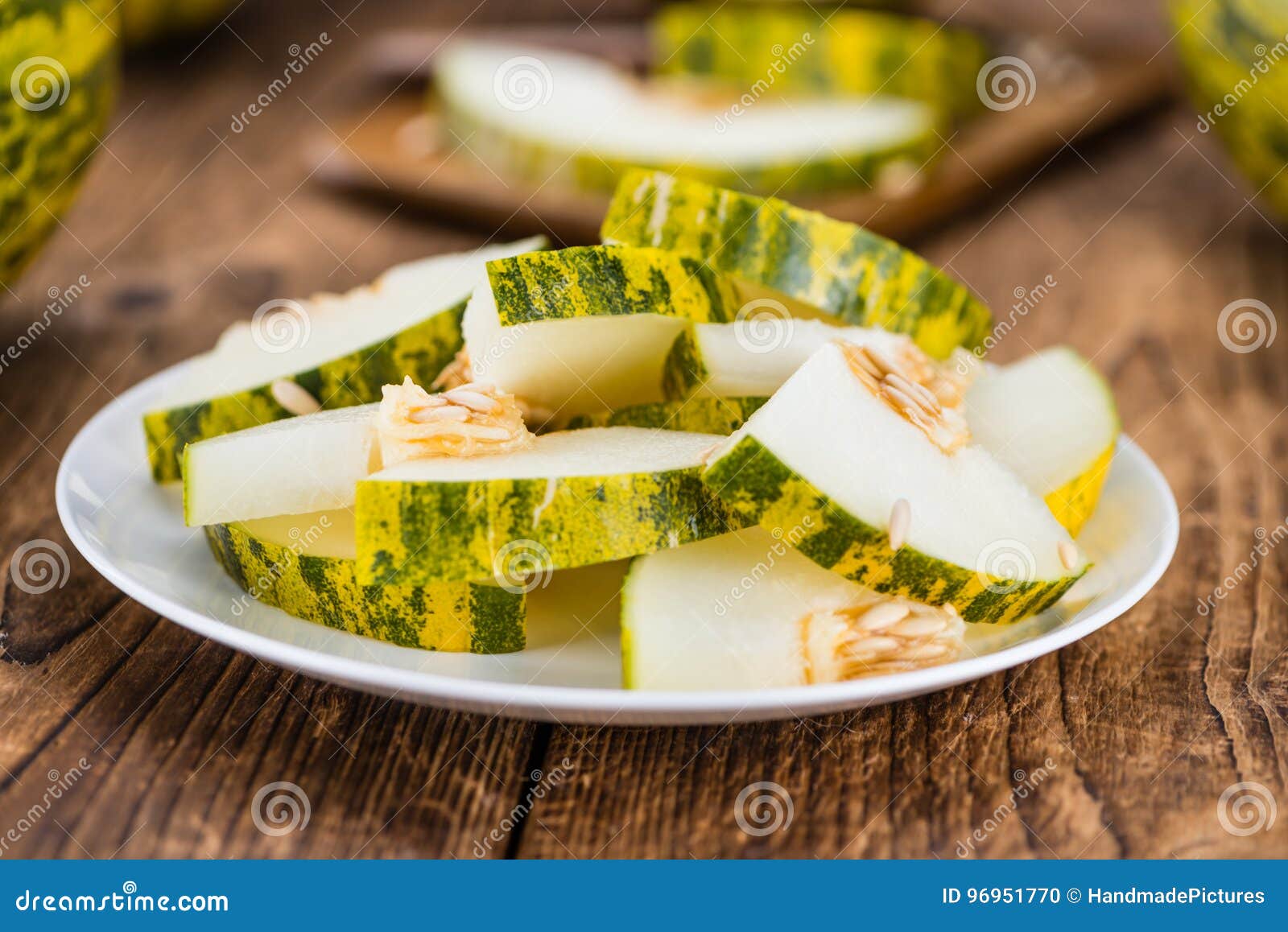 portion of fresh futuro melon on wooden background selective fo