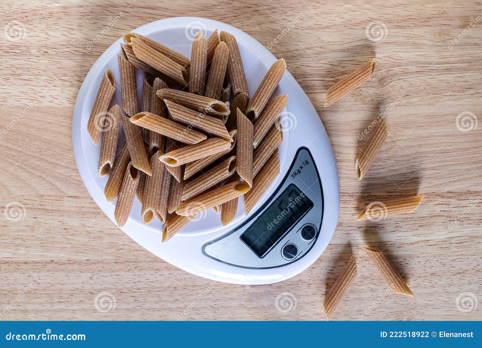A Portion 50 Gm of Pasta Penne on a Kitchen Scales, Flat Lay Stock
