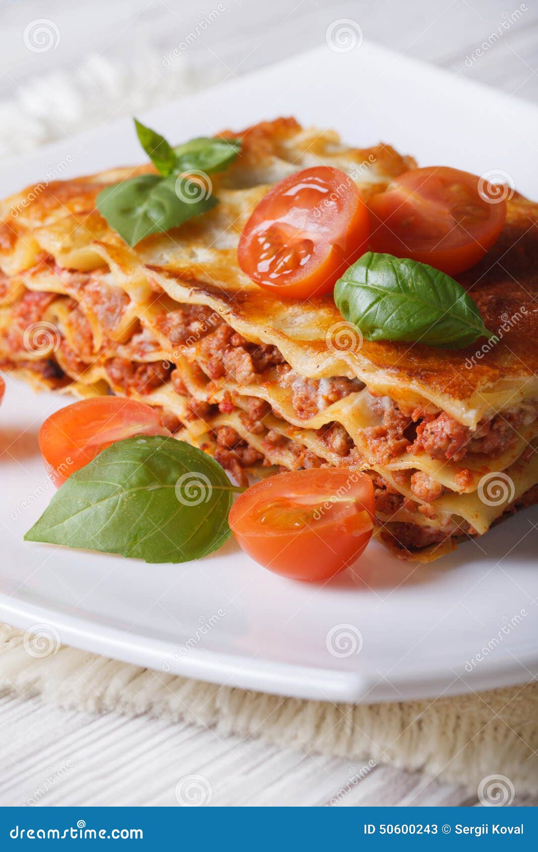 Portion of Italian Lasagna on a White Plate. Vertical Stock Image