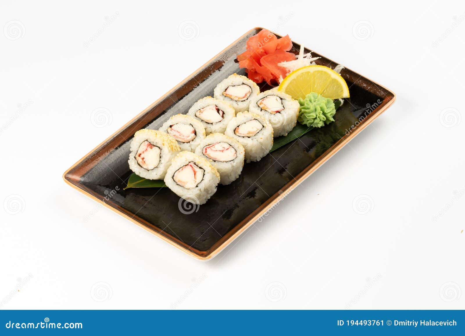 A Portion of Maki Sushi with an Assortment of Japanese Side Dishes in a Rectangular Ceramic