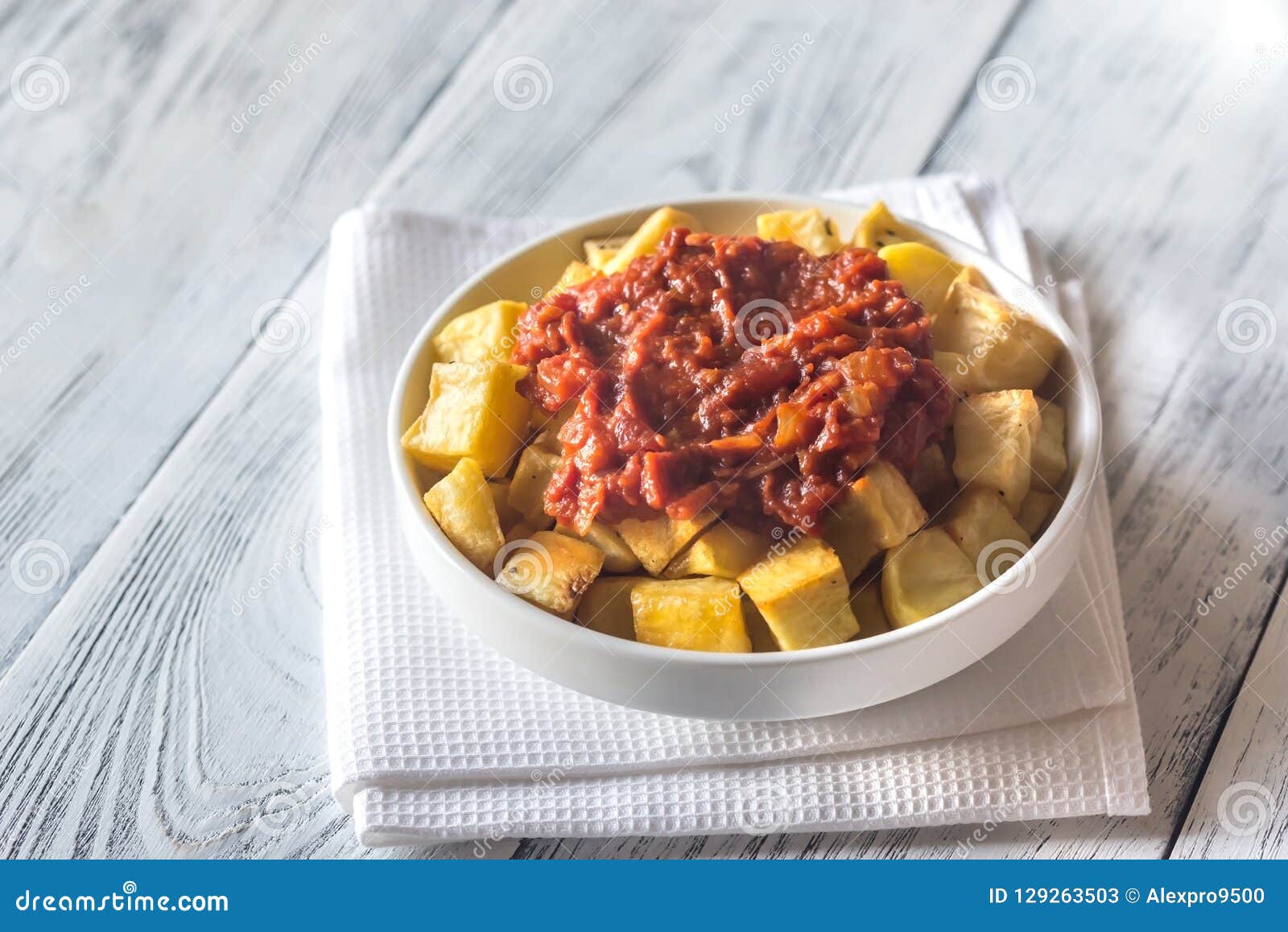 A Portion Of Patatas Bravas Over A Metallic Table. Fried Potatoes