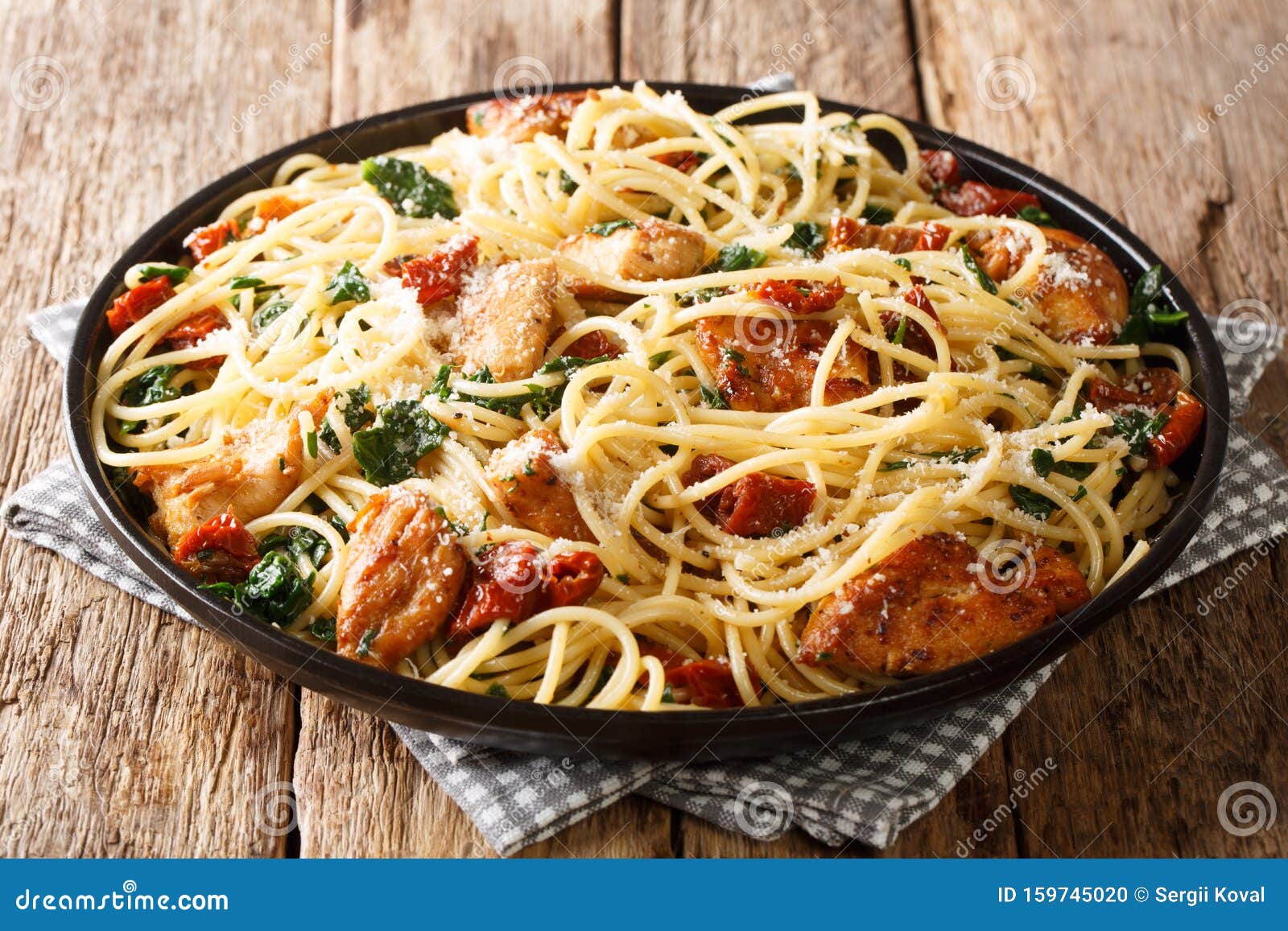 Portion of Spaghetti with Dried Tomatoes, Sliced Chicken, Parmesan and