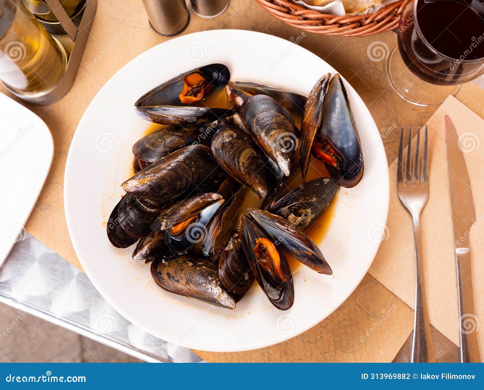portion of steamed mussels served with bay leaf on plate. spanish dish mejillon la marinera
