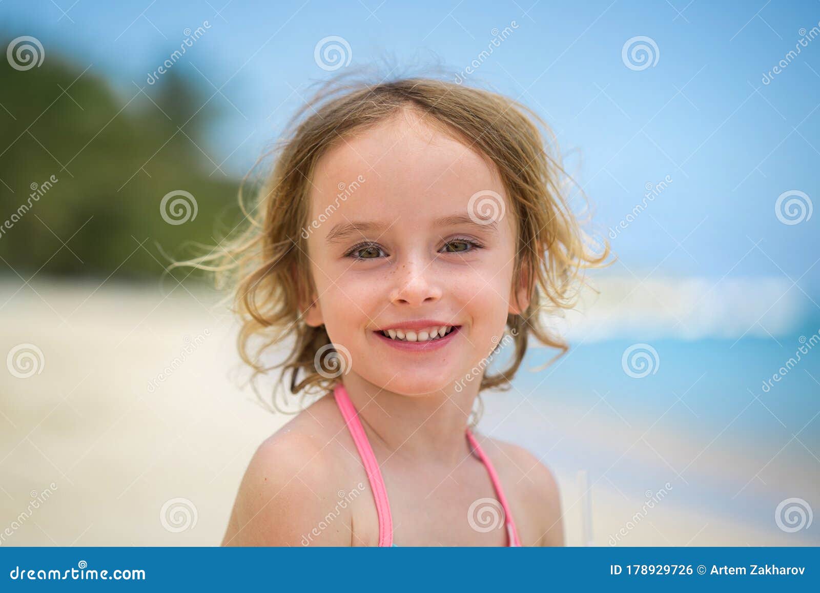 Portrait of adorable little girl at beach during summer vacation