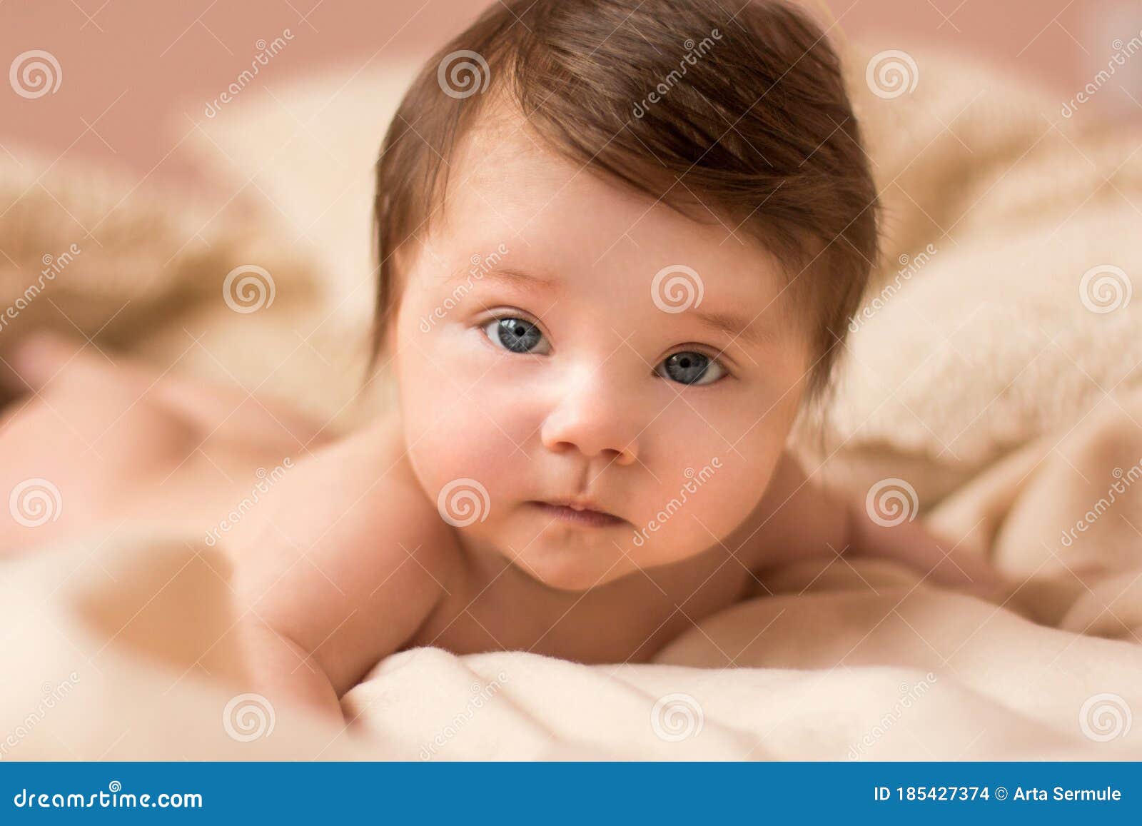 Portrait of Adorable Smiling Newborn Baby with Thick Brown Hair . Newborn  Child Relaxing in Bed Stock Photo - Image of happy, child: 185427374