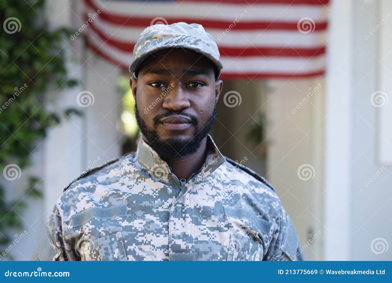 Portrait of African American Male Soldier Standing in Front of American ...