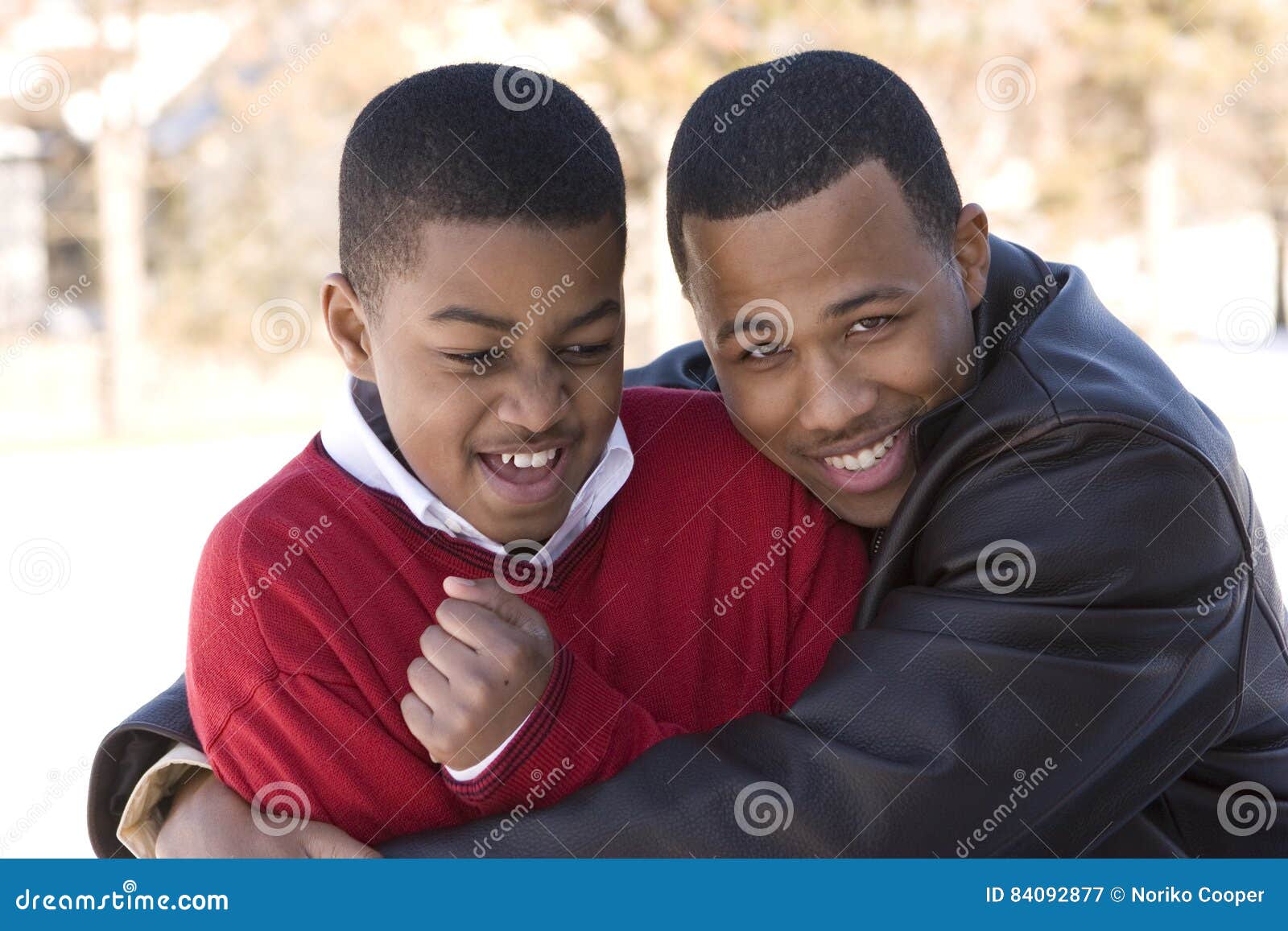 portrait of african american teenage brothers smiling.