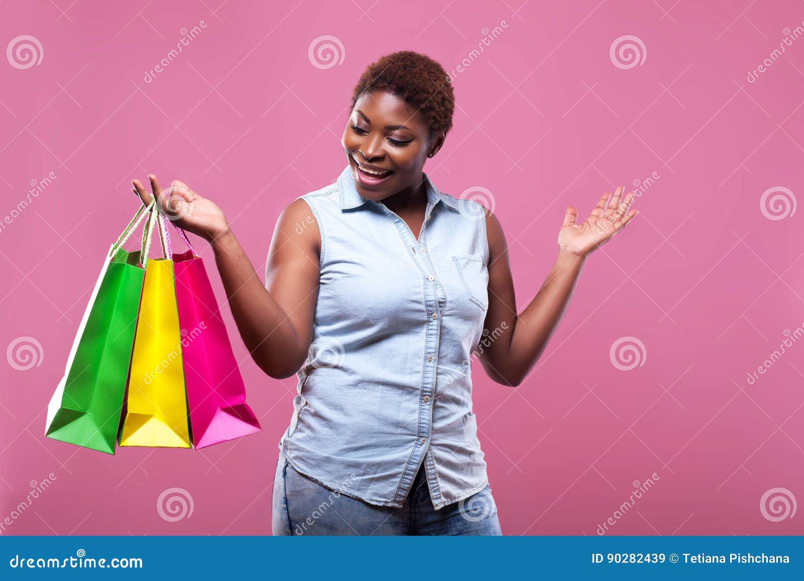 Portrait of African American Woman Carrying Shopping Bags Agains Stock ...