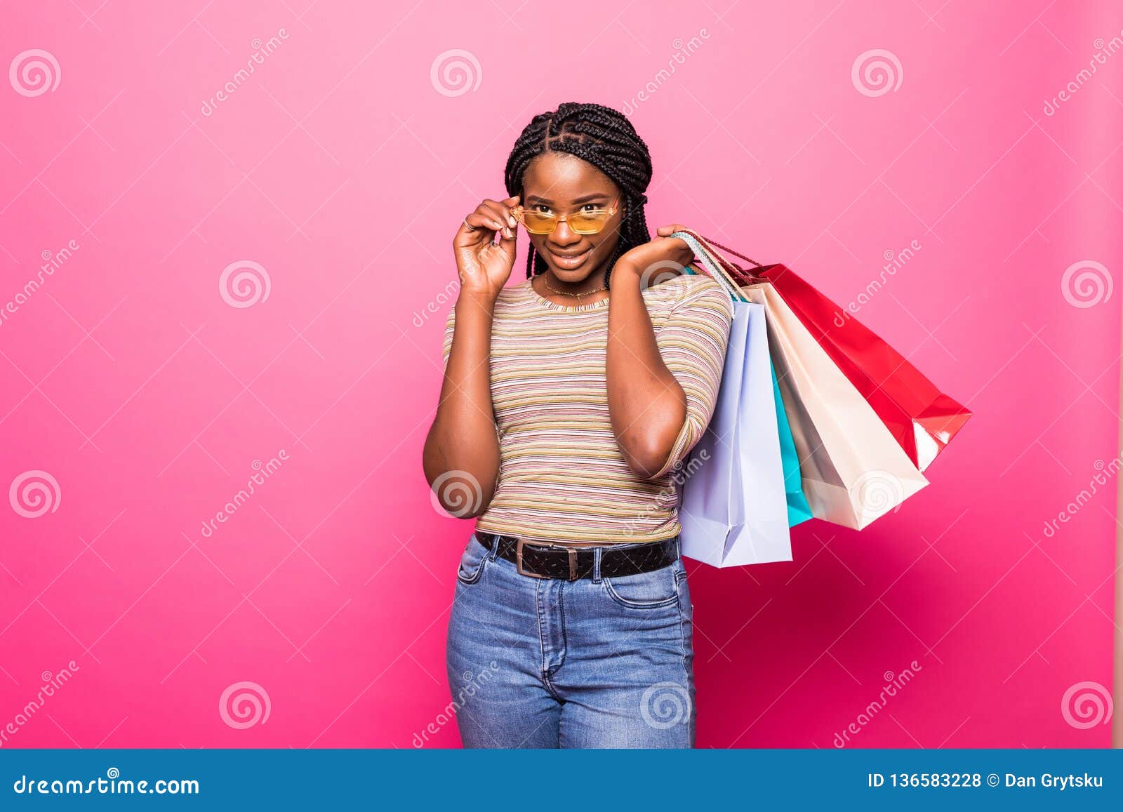 Portrait of African American Woman Carrying Shopping Bags Agains Pink ...