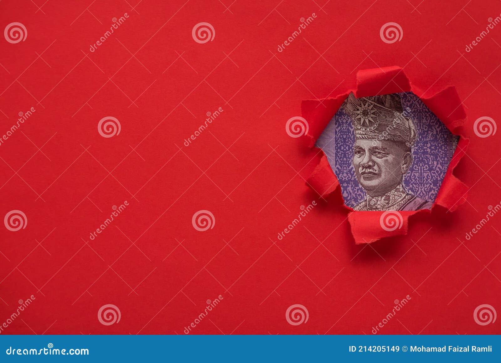 portrait of almarhum tuanku abdul rahman ibni almarhum tuanku muhammad on a ringgit bill of a red torn paper with copy space