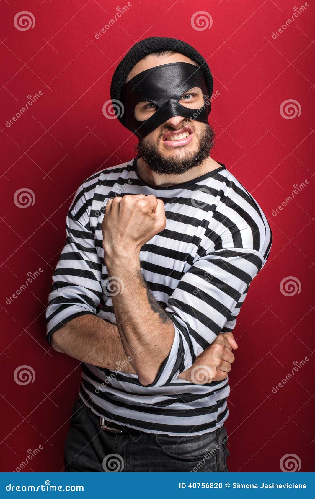 portrait of a angry bandit threaten with a fist