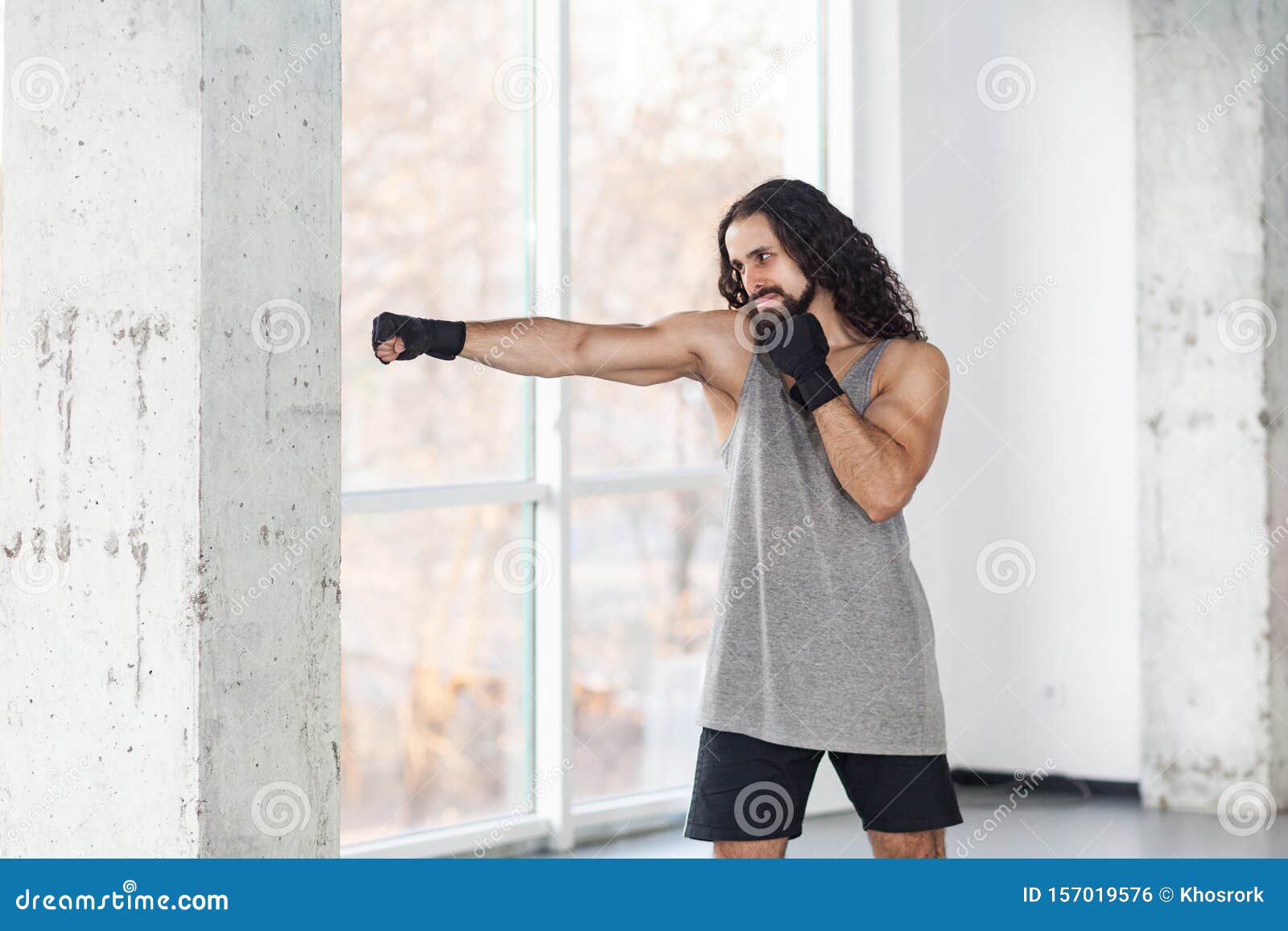 Portrait of Angry Muscular Young Adult Man with Curly Long Hair Standing and Preparing To Fight Wall with Fist in Black Gloves, Stock Photo - Image of hate, confident: 157019576 Portrait of Angry Muscular Young Adult Man with Curly Long Hair Standing and Preparing To Fight Wall with Fist in Black Gloves, Stock Photo - Image of hate, confident: 157019576
