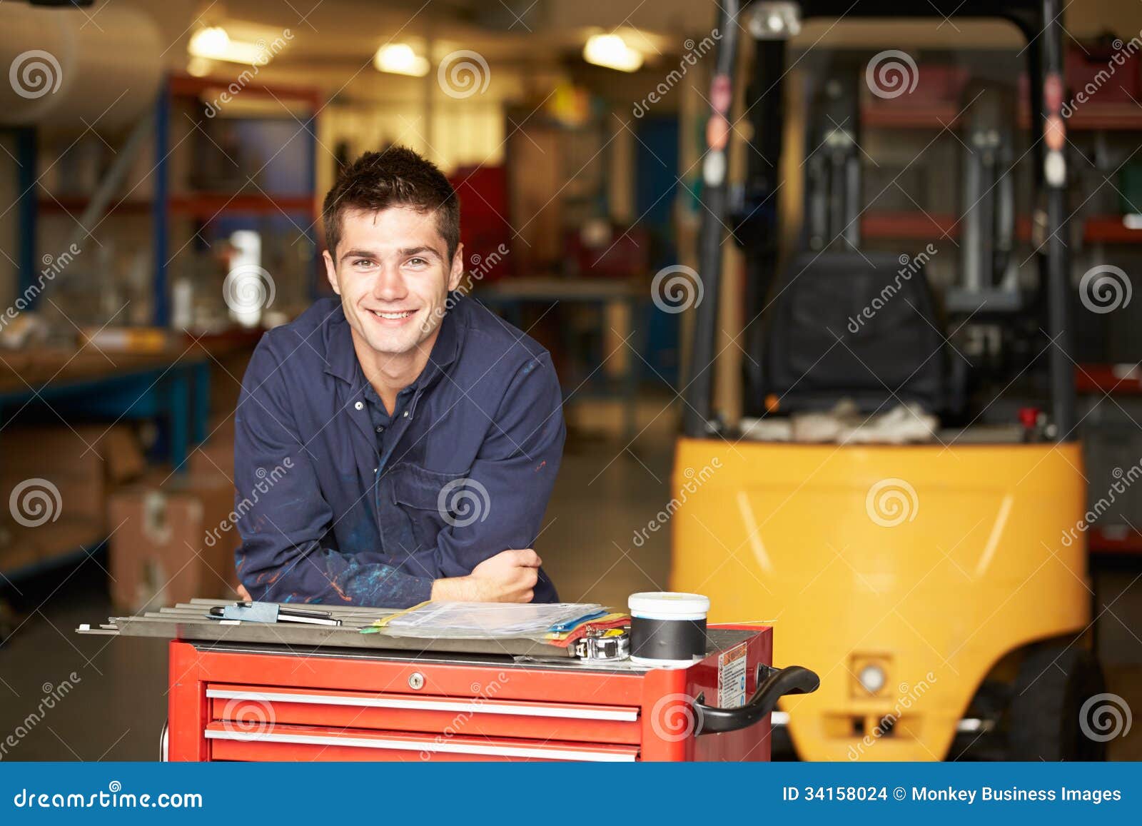 portrait of apprentice engineer in factory