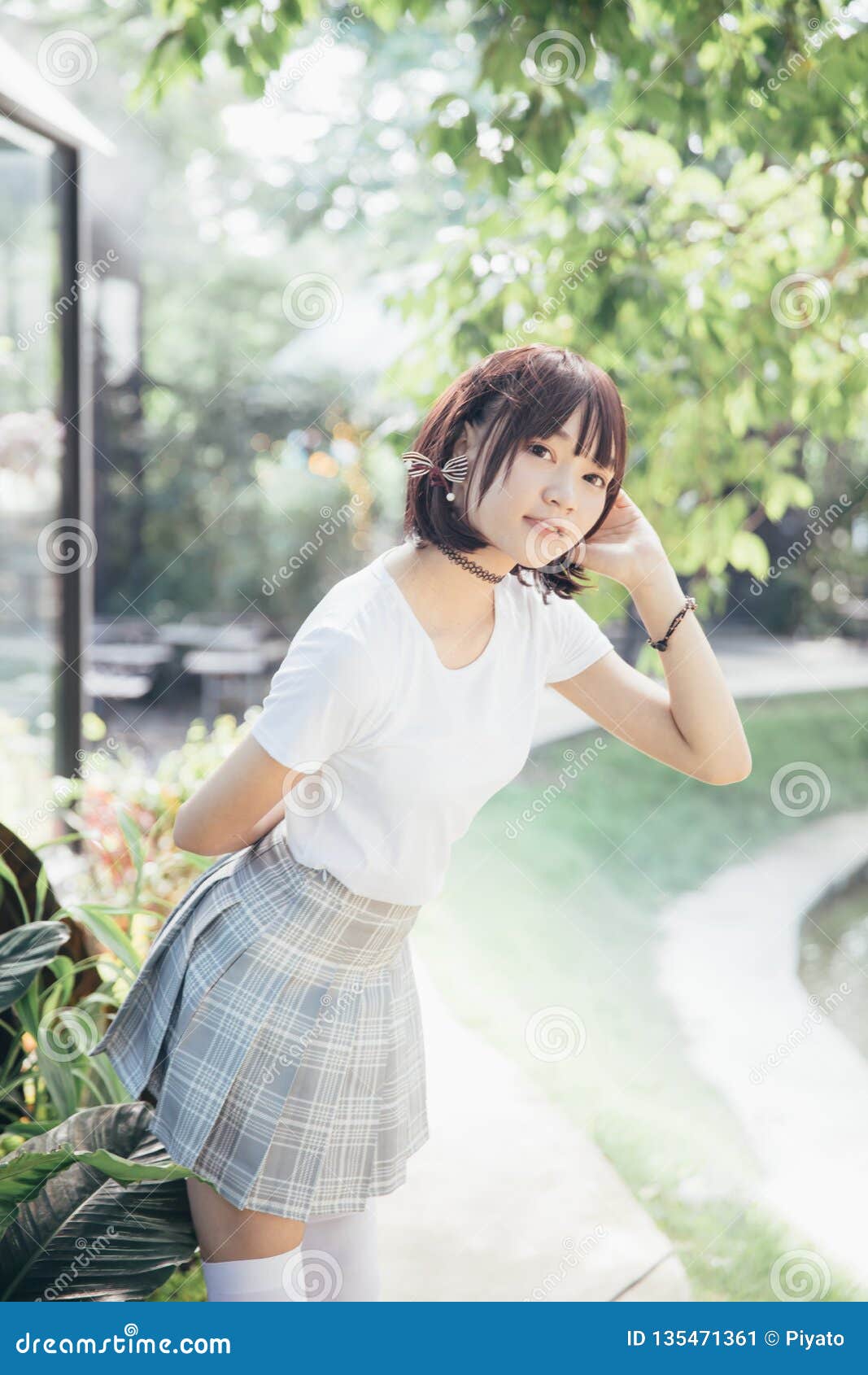 Portrait Of Asian Girl With White Shirt And Skirt Looking In Outdoor Nature Vintage Film Style