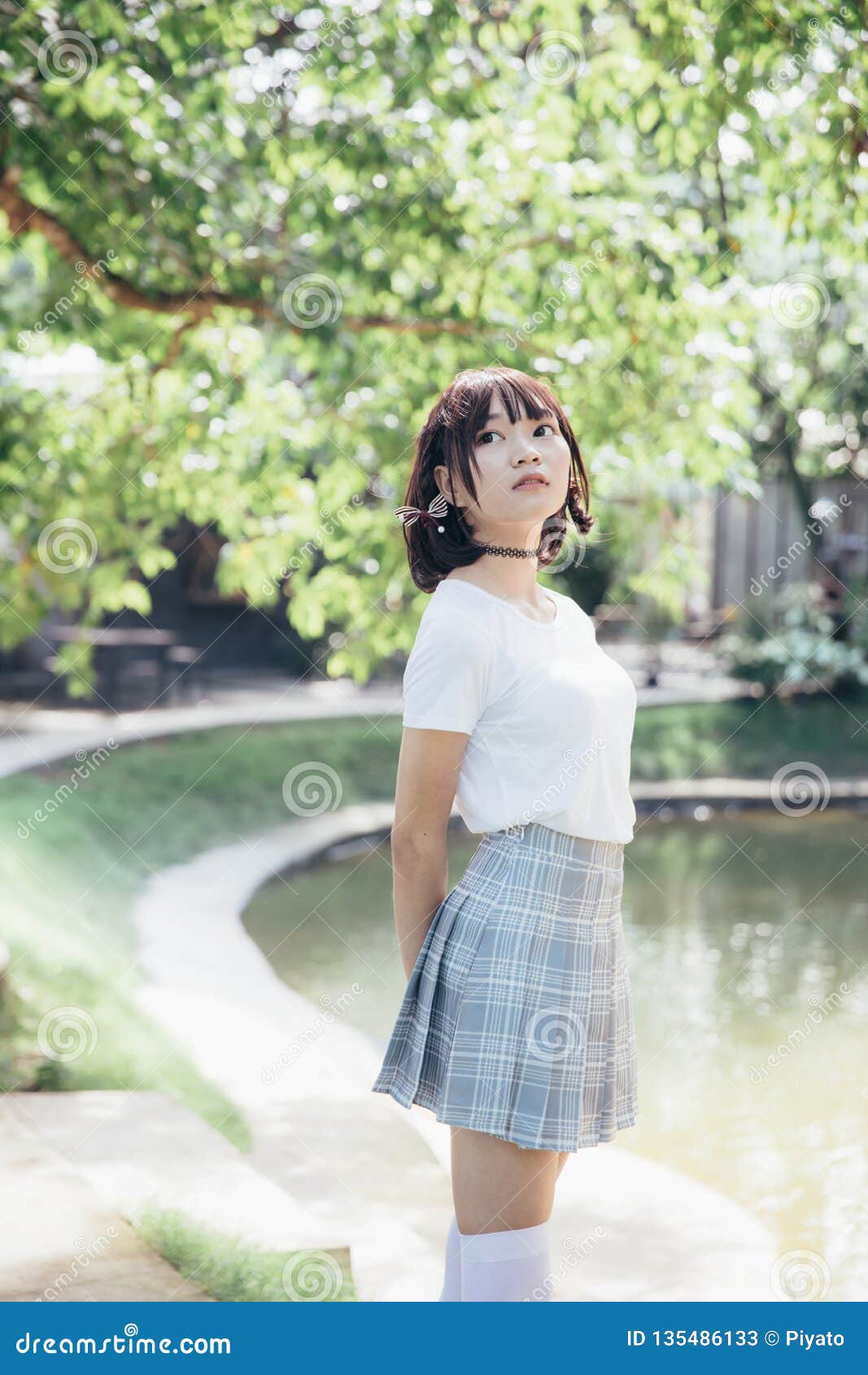 Portrait Of Asian Girl With White Shirt And Skirt Looking In Outdoor Nature Vintage Film Style