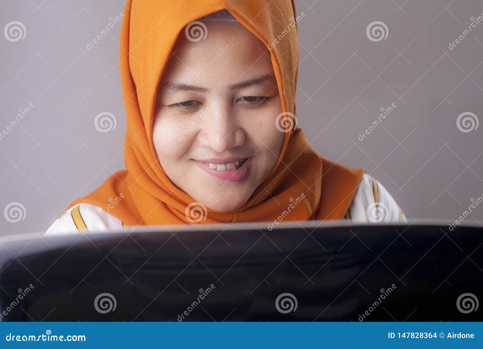 Woman With Naughty Expression Looking At Laptop Stock Photo ...