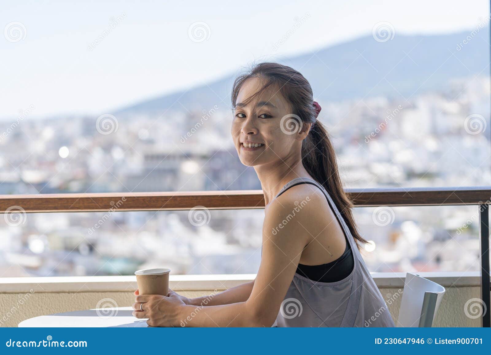 Portrait of an Asian Woman with Sportswear Sitting on the Balcony Against  City Skyline Stock Photo - Image of female, balcony: 230647946