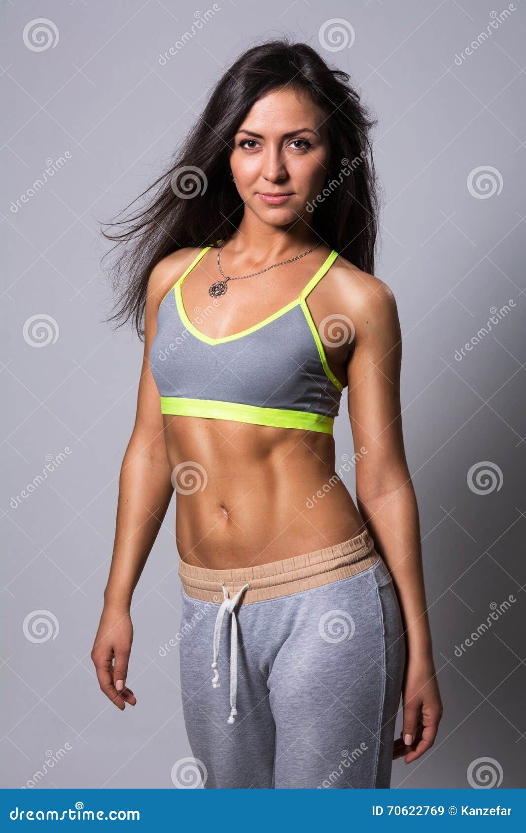 A cute athletic brunette girl, in a tight-fitting sports uniform, sits,  rests after a workout, in black kneecaps, with a bottle for sports  nutrition Stock Photo - Alamy