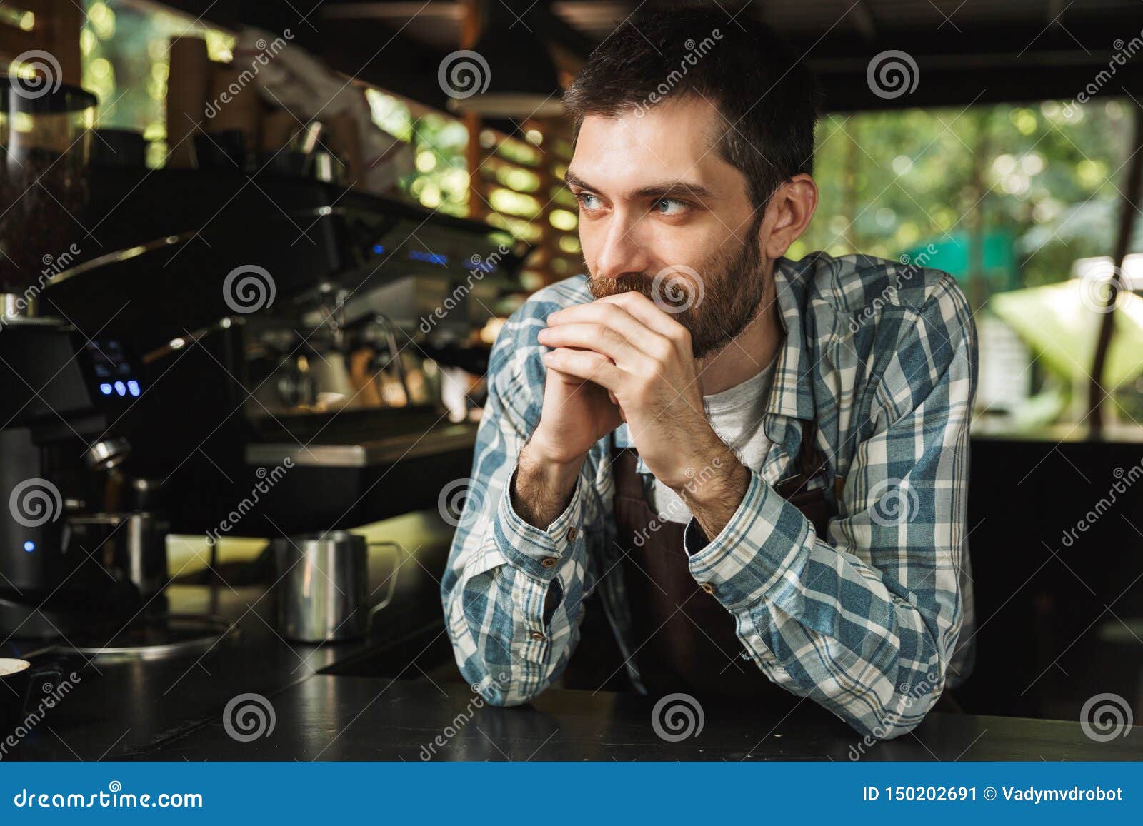 Portrait of Attractive Barista Guy Smiling while Working in Street Cafe or Coffeehouse Outdoor