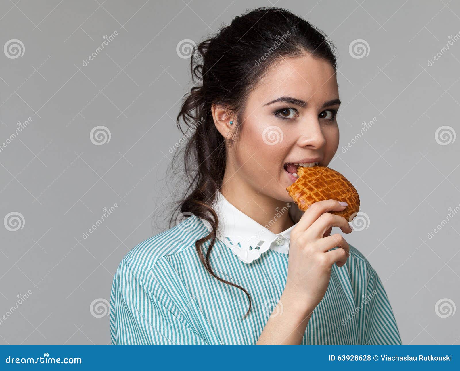 Portrait of an Attractive Biting a Biscuit Stock Photo Image