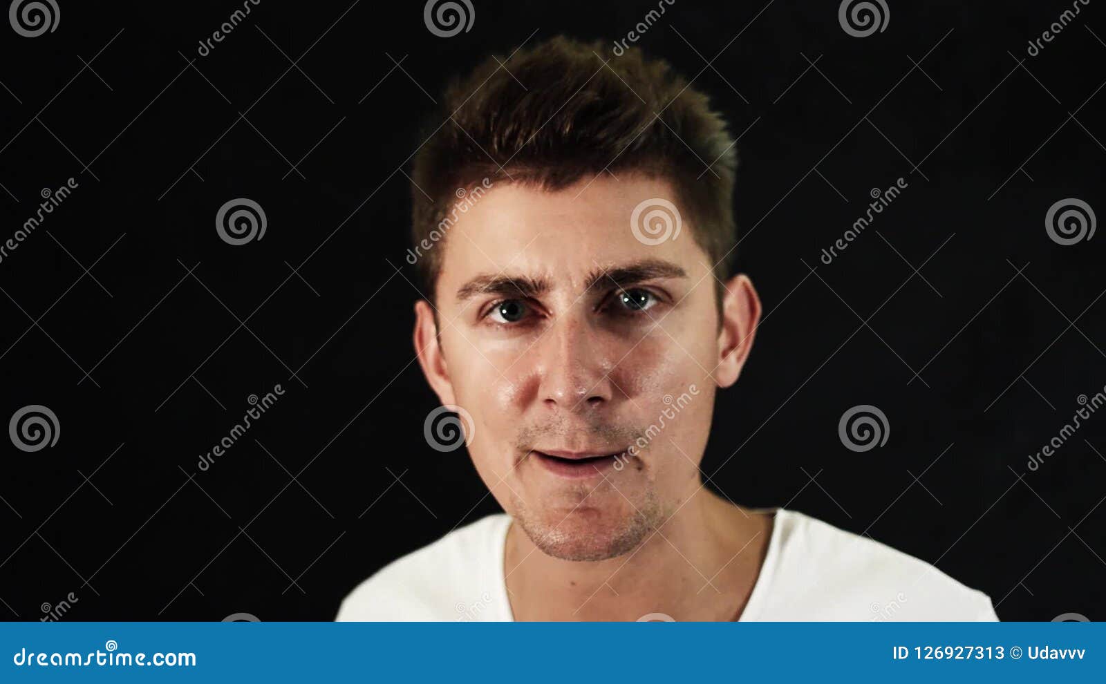 Portrait Of Attractive Dark Hair Man With Cute Big Blue Eyes Speaking On Camera